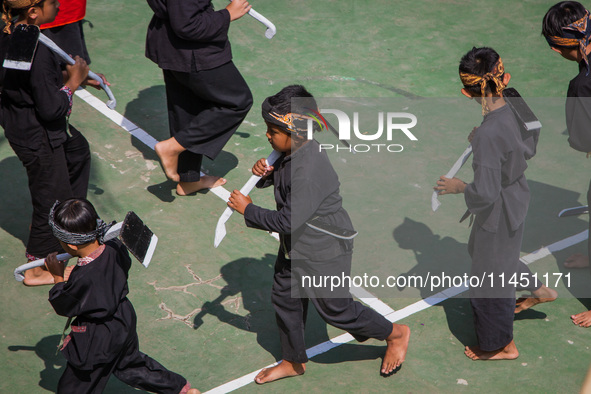 Children are taking part in the Ngemban Taun traditional ceremony on August 3, 2024, in Cireundeu Village, West Java, Indonesia. Ngemban Tau...