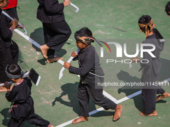 Children are taking part in the Ngemban Taun traditional ceremony on August 3, 2024, in Cireundeu Village, West Java, Indonesia. Ngemban Tau...