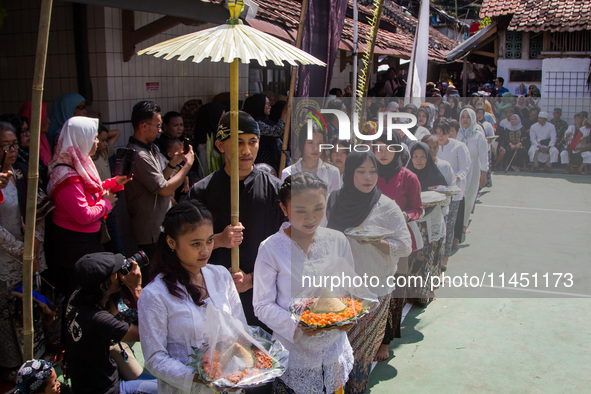 The Cireundeu Indigenous people are taking part in the Ngemban Taun traditional ceremony in Cireundeu Village, West Java, Indonesia, on Augu...