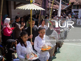 The Cireundeu Indigenous people are taking part in the Ngemban Taun traditional ceremony in Cireundeu Village, West Java, Indonesia, on Augu...