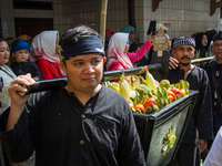 Cireundeu Indigenous people are bringing the 'Gunungan', a sacrifice in the shape of a mountain, during the Ngemban Taun traditional ceremon...