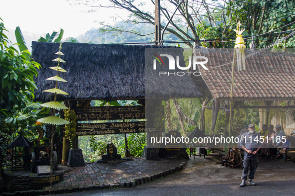 A man is standing guard during the Ngemban Taun traditional ceremony in Cireundeu Village, West Java, Indonesia, on August 3, 2024. Ngemban...