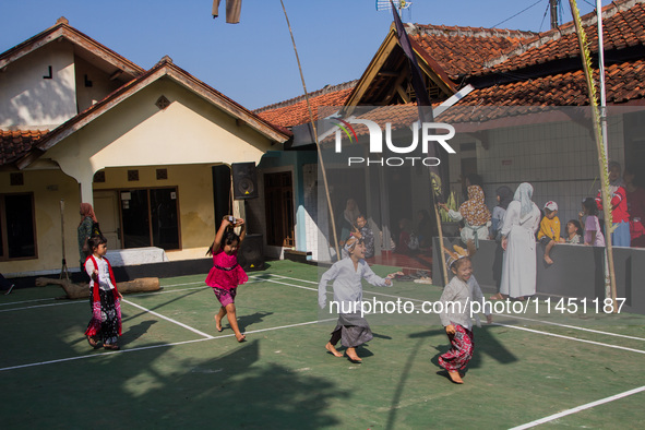 Children are playing during the Ngemban Taun traditional ceremony in Cireundeu Village, West Java, Indonesia, on August 3, 2024. Ngemban Tau...