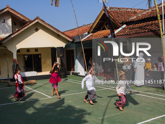 Children are playing during the Ngemban Taun traditional ceremony in Cireundeu Village, West Java, Indonesia, on August 3, 2024. Ngemban Tau...