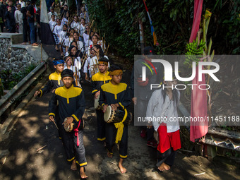 The Cireundeu Indigenous people are taking part in the Ngemban Taun traditional ceremony in Cireundeu Village, West Java, Indonesia, on Augu...