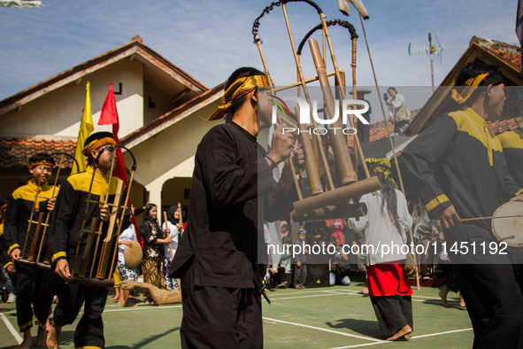 The Cireundeu Indigenous people are performing Angklung Buncis during the Ngemban Taun traditional ceremony in Cireundeu Village, West Java,...