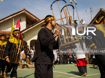 The Cireundeu Indigenous people are performing Angklung Buncis during the Ngemban Taun traditional ceremony in Cireundeu Village, West Java,...