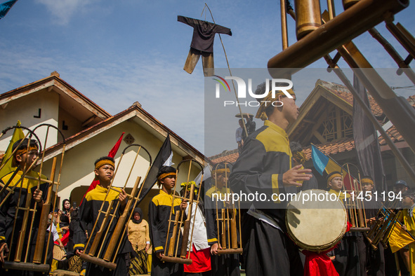 The Cireundeu Indigenous people are performing Angklung Buncis during the Ngemban Taun traditional ceremony in Cireundeu Village, West Java,...