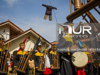 The Cireundeu Indigenous people are performing Angklung Buncis during the Ngemban Taun traditional ceremony in Cireundeu Village, West Java,...