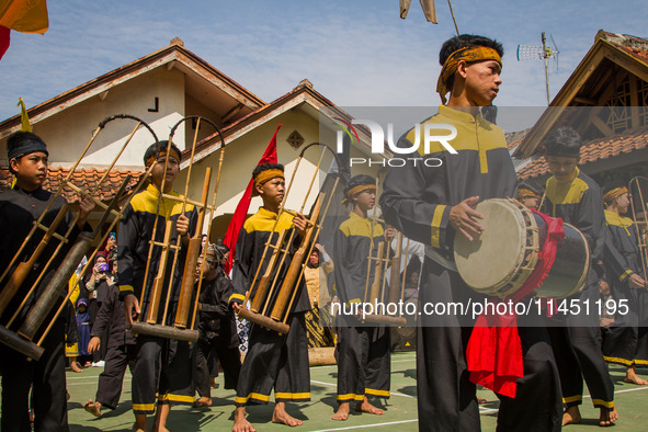 The Cireundeu Indigenous people are performing Angklung Buncis during the Ngemban Taun traditional ceremony in Cireundeu Village, West Java,...