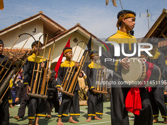 The Cireundeu Indigenous people are performing Angklung Buncis during the Ngemban Taun traditional ceremony in Cireundeu Village, West Java,...