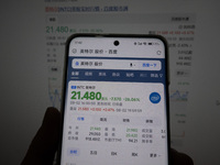 A young man is checking the share price of Intel on his mobile phone and computer in Shanghai, China, on August 3, 2024. Intel shares are fa...