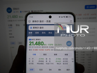 A young man is checking the share price of Intel on his mobile phone and computer in Shanghai, China, on August 3, 2024. Intel shares are fa...