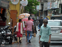 People are using umbrellas as they walk during a continuous rainfall in Siliguri, India, on August 3, 2024. (