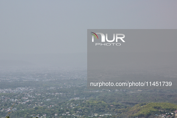 Smog is causing obscuration of the town of Dehradun in Uttarakhand, India, on April 19, 2024, due to active forest fires. 