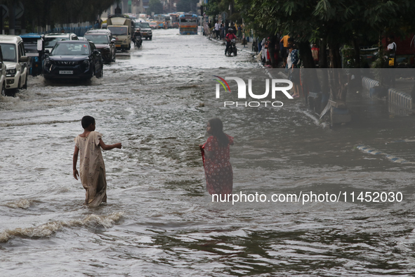 Vehicles are driving through a flooded street during the heavy monsoon rain in Kolkata, India, on August 3, 2024. 