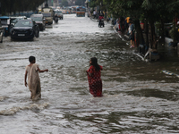 Vehicles are driving through a flooded street during the heavy monsoon rain in Kolkata, India, on August 3, 2024. (