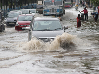 Vehicles are driving through a flooded street during the heavy monsoon rain in Kolkata, India, on August 3, 2024. (