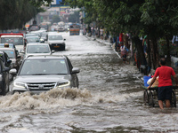 Vehicles are driving through a flooded street during the heavy monsoon rain in Kolkata, India, on August 3, 2024. (