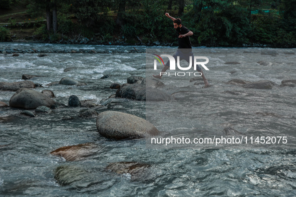 Tourists are enjoying in River Lidder on a hot summer day in Pahalgam, Jammu and Kashmir, India, on August 3, 2024. 