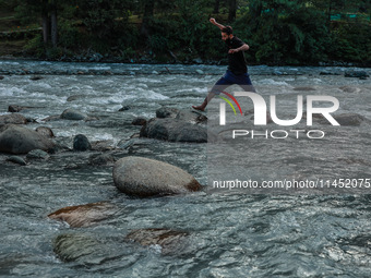 Tourists are enjoying in River Lidder on a hot summer day in Pahalgam, Jammu and Kashmir, India, on August 3, 2024. (