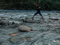 Tourists are enjoying in River Lidder on a hot summer day in Pahalgam, Jammu and Kashmir, India, on August 3, 2024. (