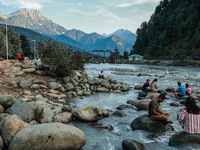 Tourists are enjoying in River Lidder on a hot summer day in Pahalgam, Jammu and Kashmir, India, on August 3, 2024. (