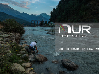 Tourists are enjoying in River Lidder on a hot summer day in Pahalgam, Jammu and Kashmir, India, on August 3, 2024. (