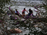 Tourists are enjoying in River Lidder on a hot summer day in Pahalgam, Jammu and Kashmir, India, on August 3, 2024. (