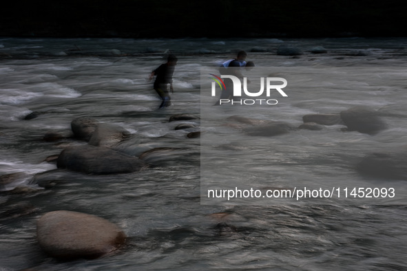 Tourists are enjoying in River Lidder on a hot summer day in Pahalgam, Jammu and Kashmir, India, on August 3, 2024. 