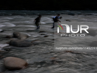 Tourists are enjoying in River Lidder on a hot summer day in Pahalgam, Jammu and Kashmir, India, on August 3, 2024. (