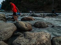 Tourists are enjoying in River Lidder on a hot summer day in Pahalgam, Jammu and Kashmir, India, on August 3, 2024. (