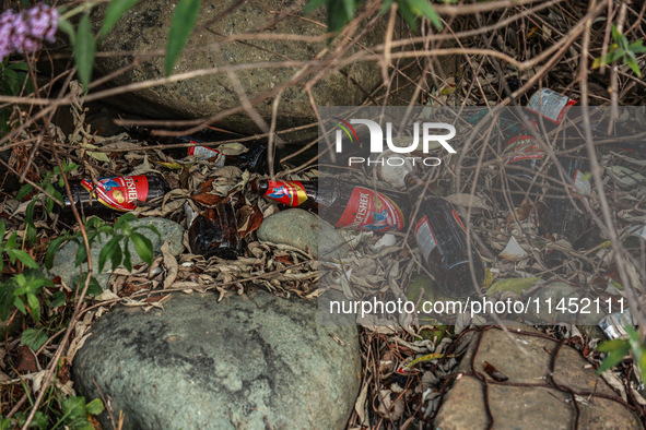 Empty bottles of Kingfisher beer are being thrown on the banks of River Lidder in Pahalgam, Jammu and Kashmir, India, on August 3, 2024. 