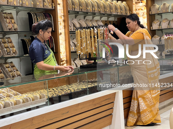 A woman is shopping for designer costume jewellery at a jewellery store in Thiruvananthapuram, Kerala, India, on April 08, 2024. (