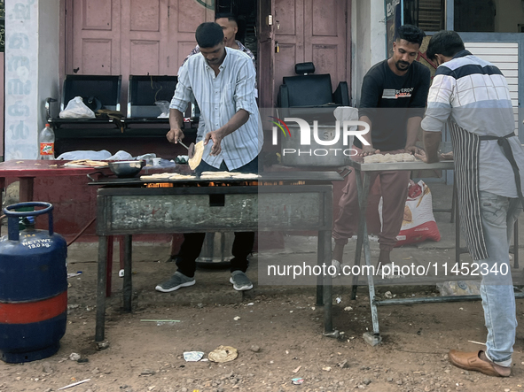 Men are preparing parotta bread along the roadside during Ramadan in Kerala, India, on April 10, 2024. 