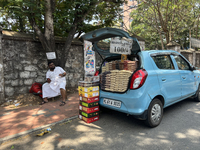 A man is selling nuts and dried fruits from the back of a vehicle along the roadside in Thiruvananthapuram (Trivandrum), Kerala, India, on M...