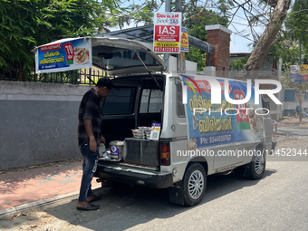 A man is selling pre-made biryani from the back of a vehicle along the roadside in Thiruvananthapuram (Trivandrum), Kerala, India, on March...