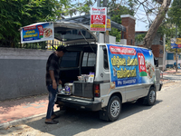 A man is selling pre-made biryani from the back of a vehicle along the roadside in Thiruvananthapuram (Trivandrum), Kerala, India, on March...