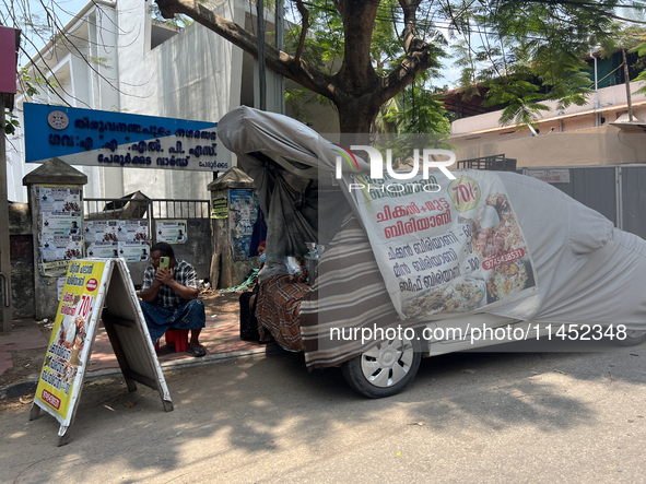 A man is selling pre-made biryani from the back of a vehicle along the roadside in Thiruvananthapuram (Trivandrum), Kerala, India, on March...