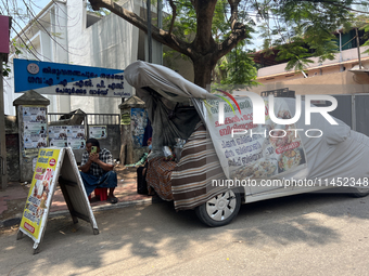 A man is selling pre-made biryani from the back of a vehicle along the roadside in Thiruvananthapuram (Trivandrum), Kerala, India, on March...