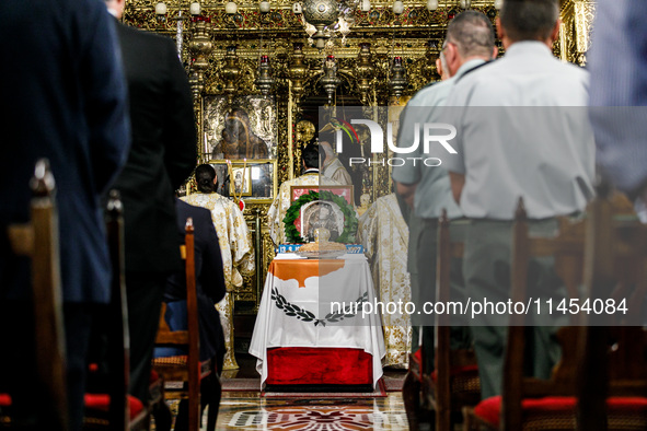 A photograph of Makarios is being seen on a table with the flag of Cyprus during the service in Kykkos, Cyprus, on August 4, 2024. The Presi...