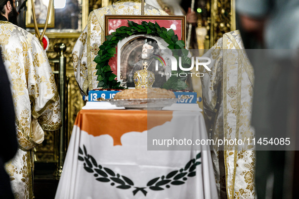 A photograph of Makarios is being seen on a table with the flag of Cyprus during the service in Kykkos, Cyprus, on August 4, 2024. The Presi...