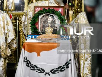 A photograph of Makarios is being seen on a table with the flag of Cyprus during the service in Kykkos, Cyprus, on August 4, 2024. The Presi...