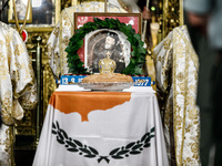 A photograph of Makarios is being seen on a table with the flag of Cyprus during the service in Kykkos, Cyprus, on August 4, 2024. The Presi...