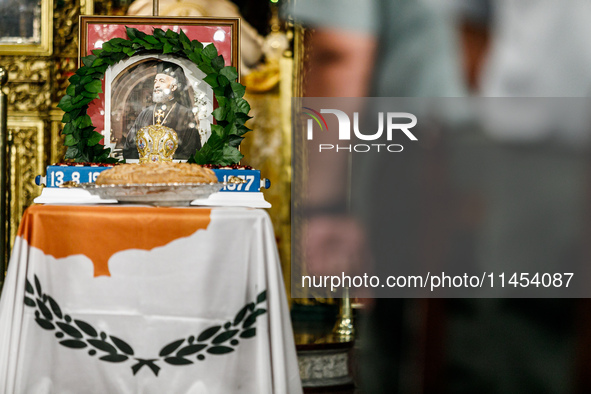 A photograph of Makarios is being seen on a table with the flag of Cyprus during the service in Kykkos, Cyprus, on August 4, 2024. The Presi...