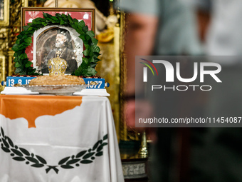 A photograph of Makarios is being seen on a table with the flag of Cyprus during the service in Kykkos, Cyprus, on August 4, 2024. The Presi...