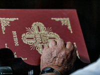 The hand of an elderly man is being seen during the service in Kykkos, Cyprus, on August 4, 2024. President of Cyprus Nikos Christodoulides...