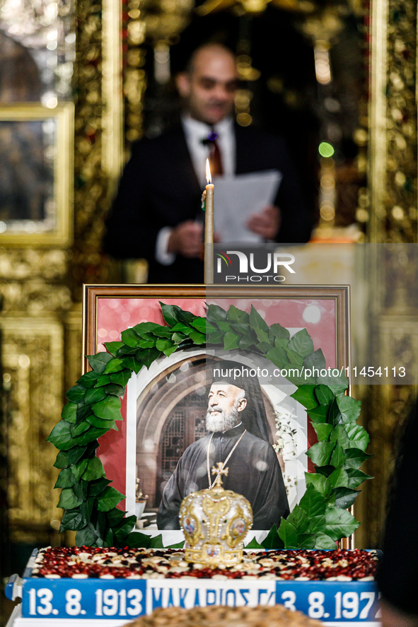 Minister of Labour Yiannis Panayiotou is giving his speech during the service behind the photograph of Makarios in Kykkos, Cyprus, on August...