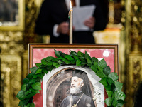 Minister of Labour Yiannis Panayiotou is giving his speech during the service behind the photograph of Makarios in Kykkos, Cyprus, on August...