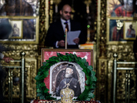 Minister of Labour Yiannis Panayiotou is giving his speech during the service behind the photograph of Makarios in Kykkos, Cyprus, on August...